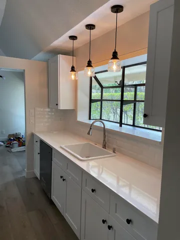 a bathroom with a sink and a window