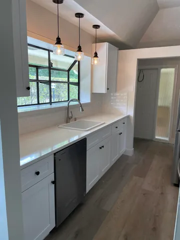 a kitchen with a sink and window