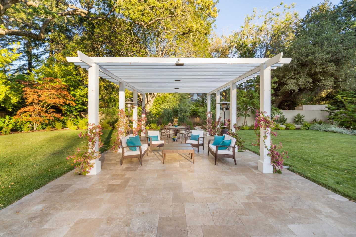 89 Selby Lane Atherton, CA 94027 - Photo 29 of 59 a view of a patio with table and chairs near a garden