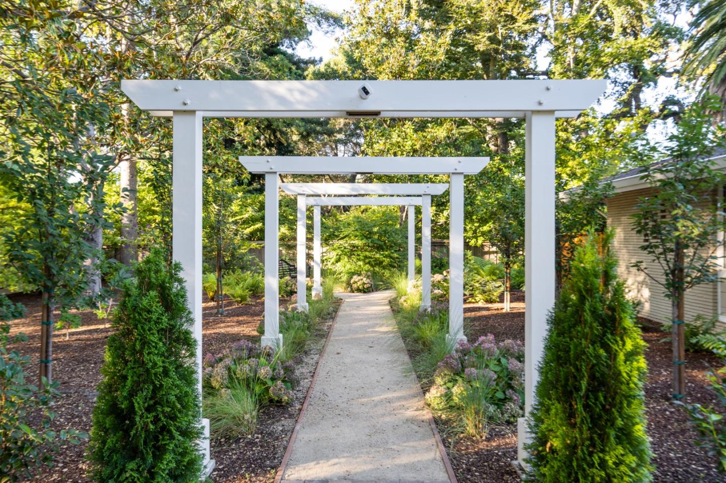 89 Selby Lane Atherton, CA 94027 - Photo 34 of 59 a view of a pathway of a house with a garden