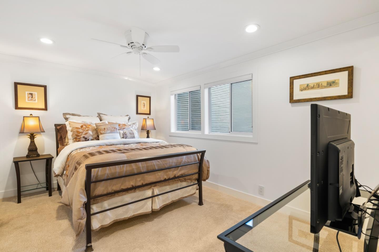 89 Selby Lane Atherton, CA 94027 - Photo 39 of 59 a bedroom with a bed and a ceiling fan