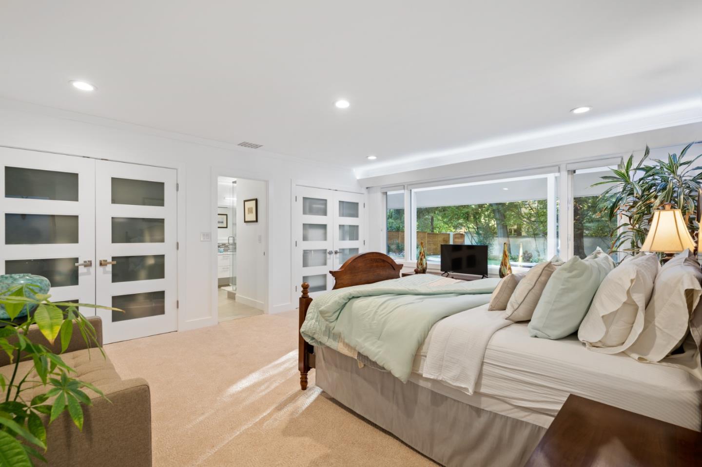 89 Selby Lane Atherton, CA 94027 - Photo 54 of 59 a bedroom with a bed table and a large window