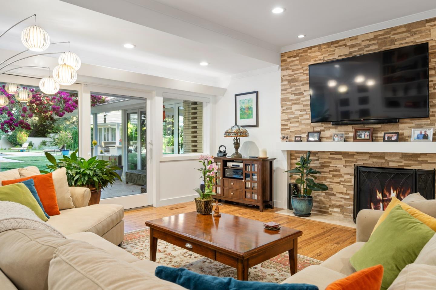 89 Selby Lane Atherton, CA 94027 - Photo 9 of 59 a living room with furniture a flat screen tv and a fireplace