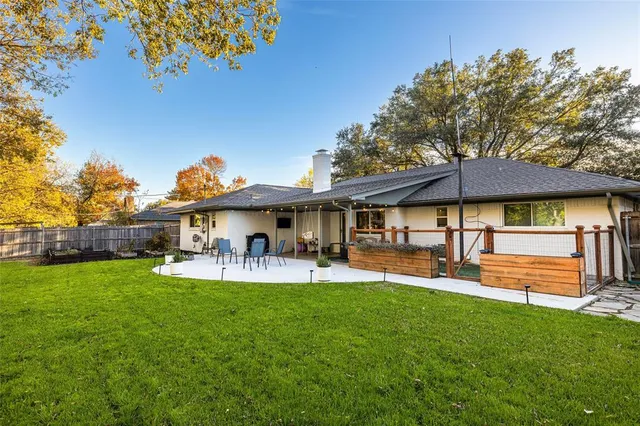 a view of a house with a yard patio and sitting area