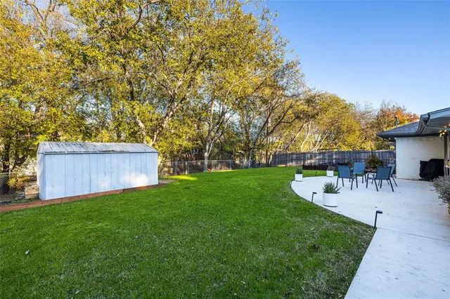 a front view of a house with garden and sitting area