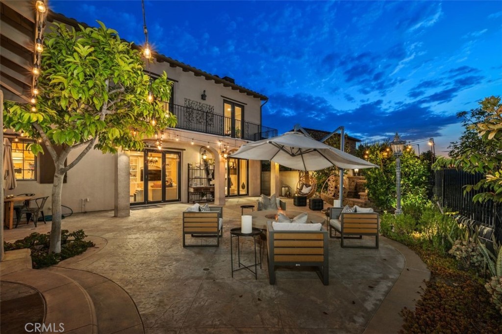 a view of a patio with table and chairs and potted plants