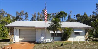 18433 Iris Road Fort Myers, FL 33967 - Photo 1 of 1 a front view of a house with a yard and garage