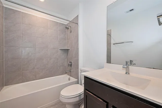 a bathroom with a sink toilet and vanity