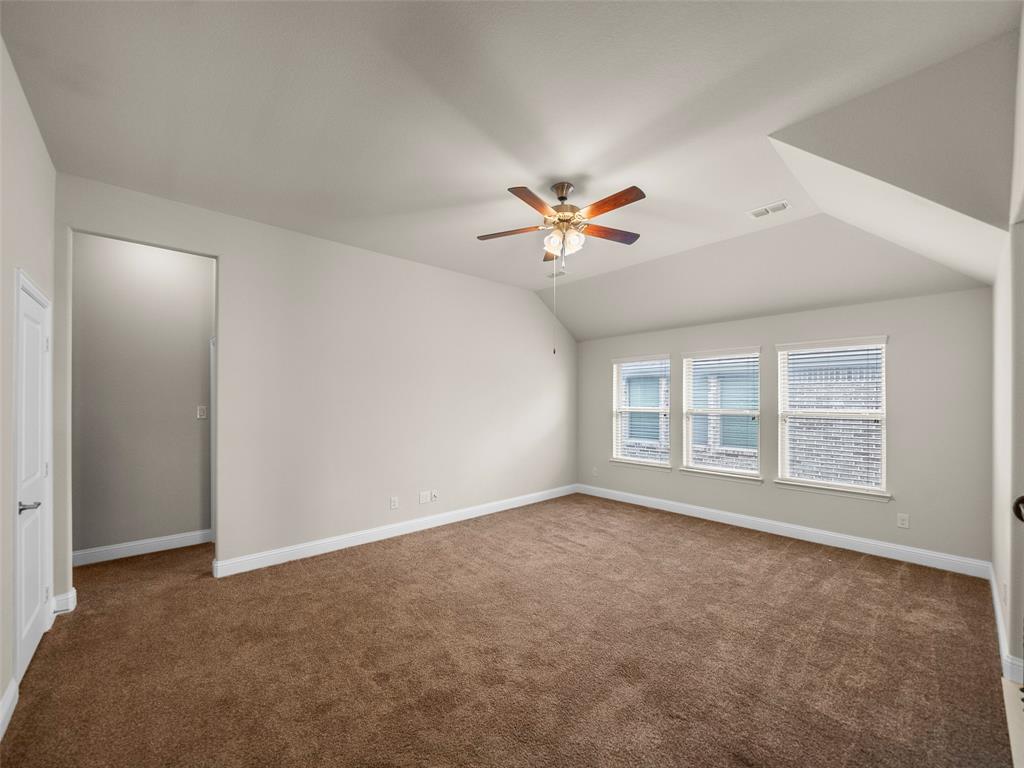 3044 Bold Ruler Road Celina, TX 75009 - Photo 18 of 36 an empty room with windows and chandelier fan