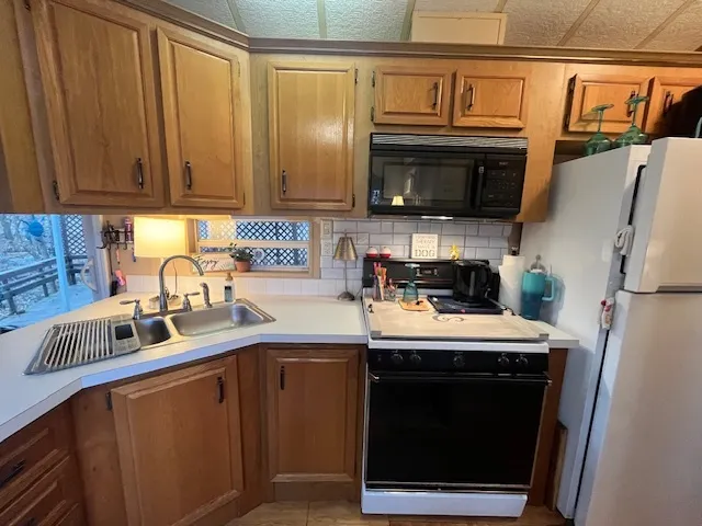 a kitchen with stainless steel appliances a stove microwave and refrigerator