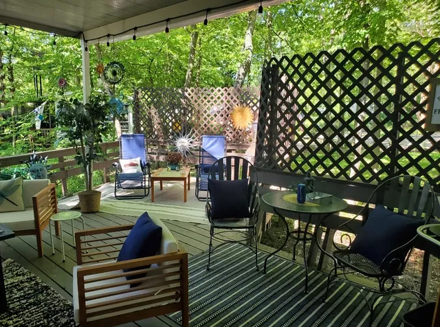 a view of backyard with wooden fence and a trees