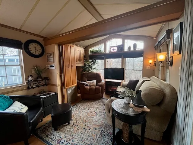 a living room with furniture and a floor to ceiling window