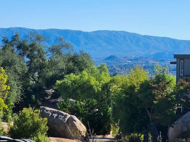 an aerial view of a house and mountain view