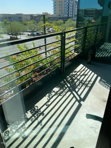 a view of a balcony with two chairs and a table