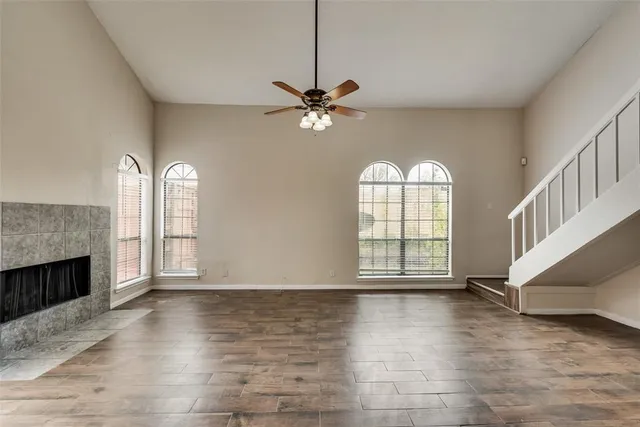 an empty room with windows and a fireplace