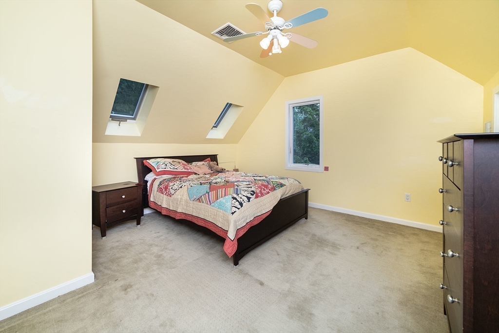 50 Bellingham Road Brookline, MA 02467 - Photo 20 of 31 a bedroom with a bed and a chandelier