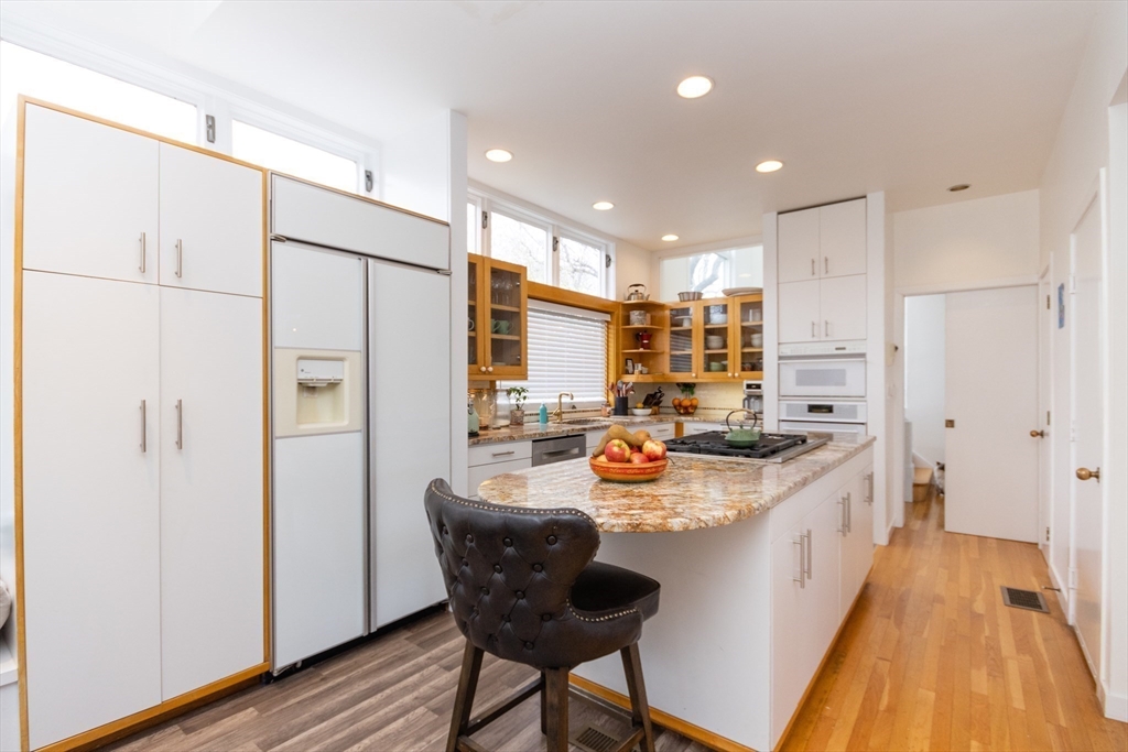 50 Bellingham Road Brookline, MA 02467 - Photo 4 of 31 a kitchen with refrigerator and chairs