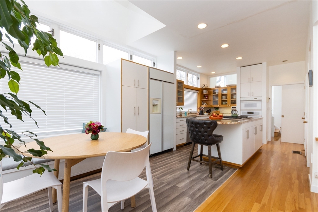 50 Bellingham Road Brookline, MA 02467 - Photo 6 of 31 a kitchen with a table chairs refrigerator and cabinets