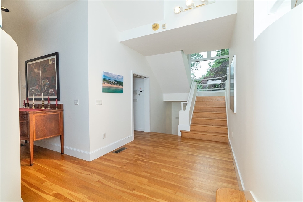 50 Bellingham Road Brookline, MA 02467 - Photo 10 of 31 a view of an empty room with wooden floor and a kitchen