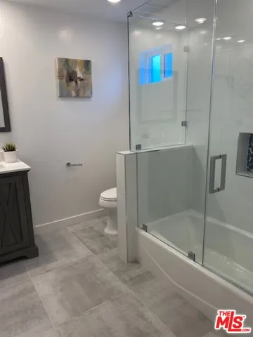 a bathroom with a shower and a toilet