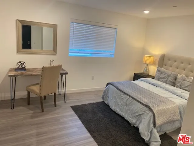 a bedroom with a bed and a table