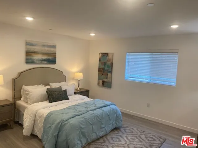 a bedroom with a bed and a night stand