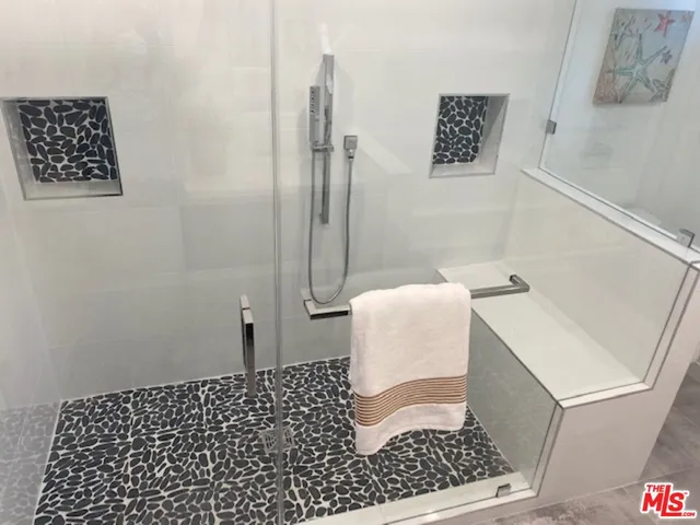 a bathroom with a sink a toilet and a shower