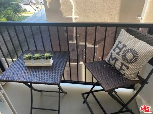 a view of a balcony with furniture