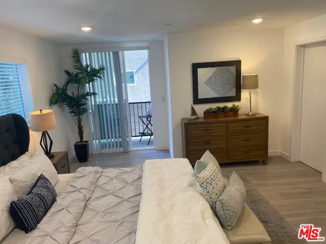 a bedroom with a bed and a flat screen television