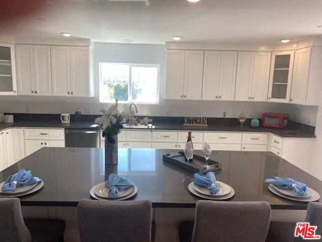 a kitchen with a white cabinets and stove