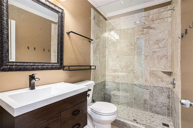 a bathroom with a sink a toilet a shower and a mirror