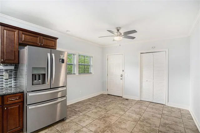 a kitchen with stainless steel appliances granite countertop a refrigerator and a stove top oven