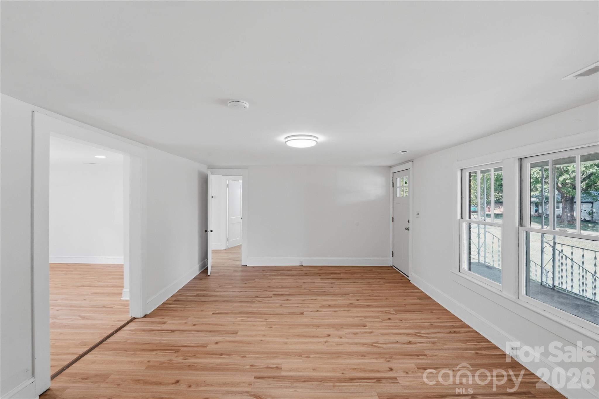 2231 Claremont Road Newton, NC 28658 - Photo 27 of 39 a view of an empty room with wooden floor and a window