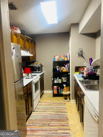 a kitchen with stainless steel appliances a stove and a refrigerator