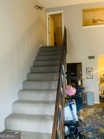 a view of a workspace with wooden floor and furniture