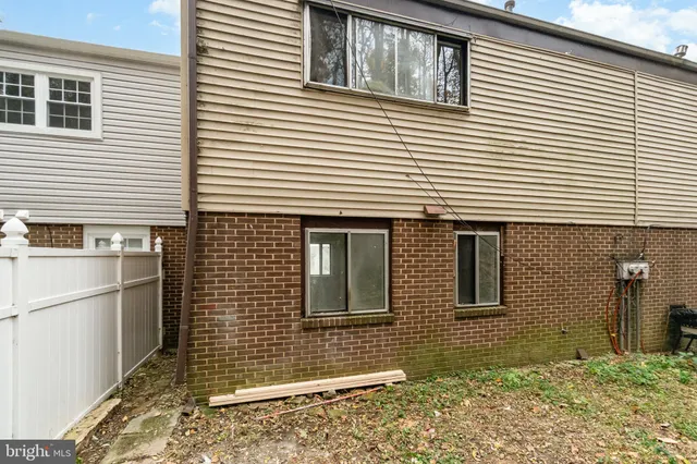 a view of a blue house with large windows