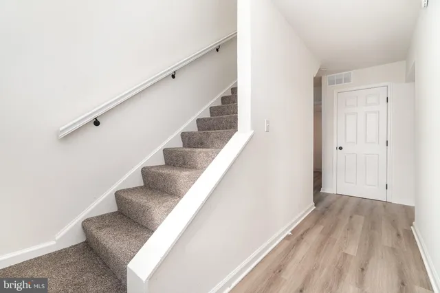 a view of entryway and hall with wooden floor