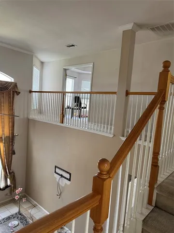 a view of staircase with wooden floor and a rug