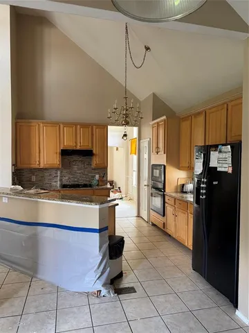 a kitchen with a refrigerator a stove top oven a sink dishwasher and cabinets with wooden floor