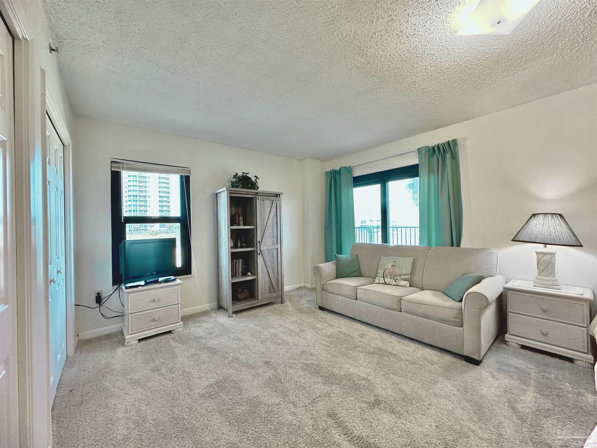 13817 Perdido Key Drive, Unit 204 Pensacola, FL 32507 - Photo 12 of 27 a living room with furniture and white walls