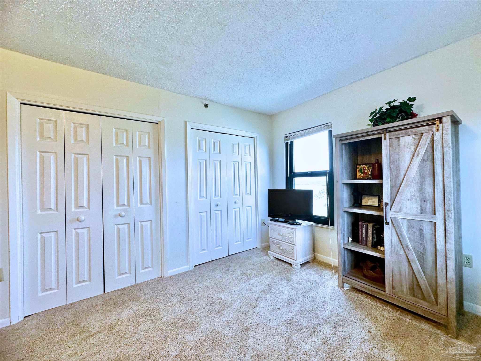13817 Perdido Key Drive, Unit 204 Pensacola, FL 32507 - Photo 13 of 27 a view of a livingroom with furniture and a flat screen tv