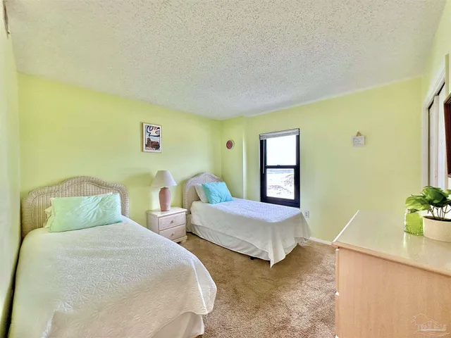 a bedroom with two beds and painting on the wall