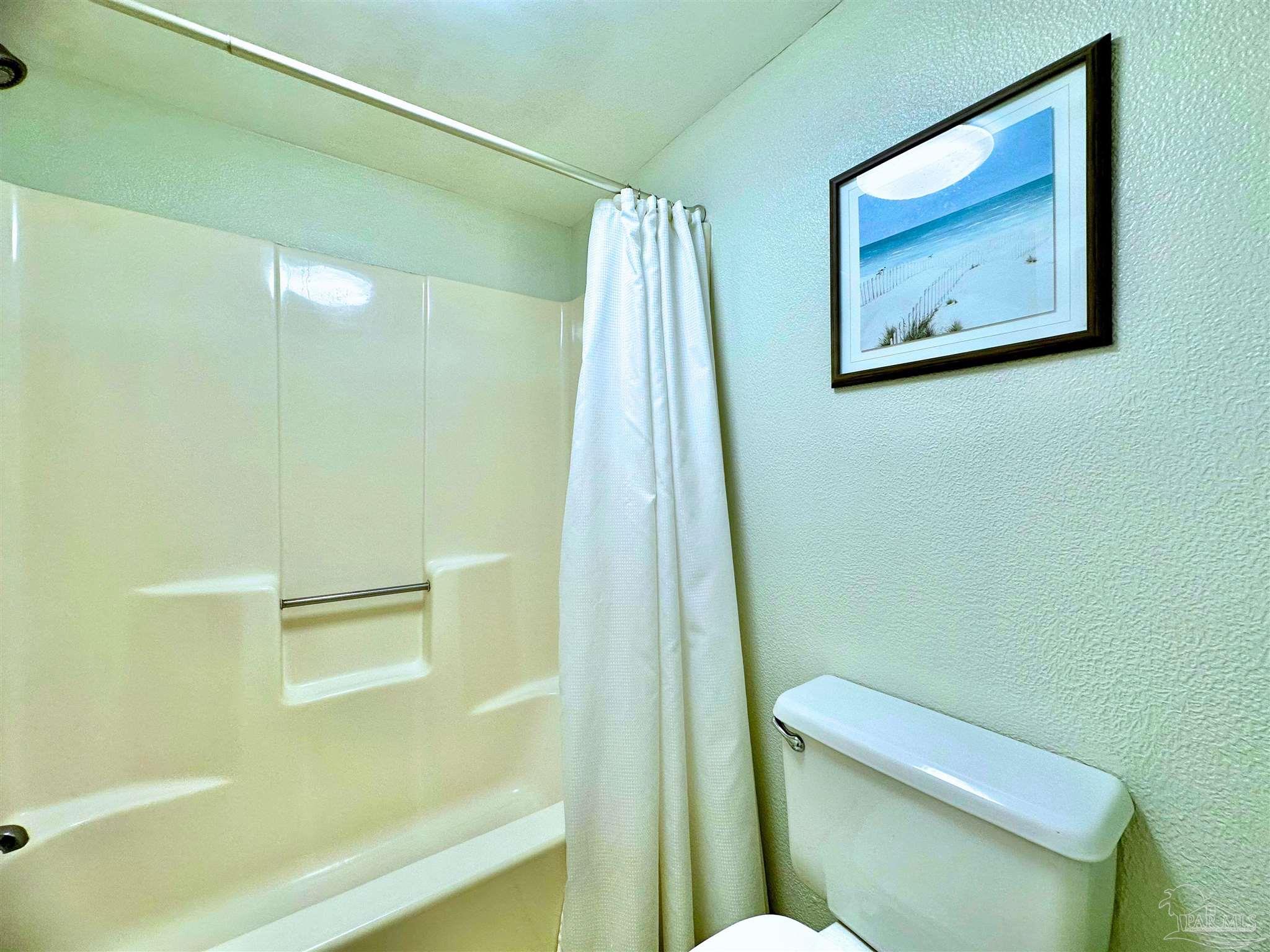 13817 Perdido Key Drive, Unit 204 Pensacola, FL 32507 - Photo 20 of 27 a bathroom with a toilet and a shower
