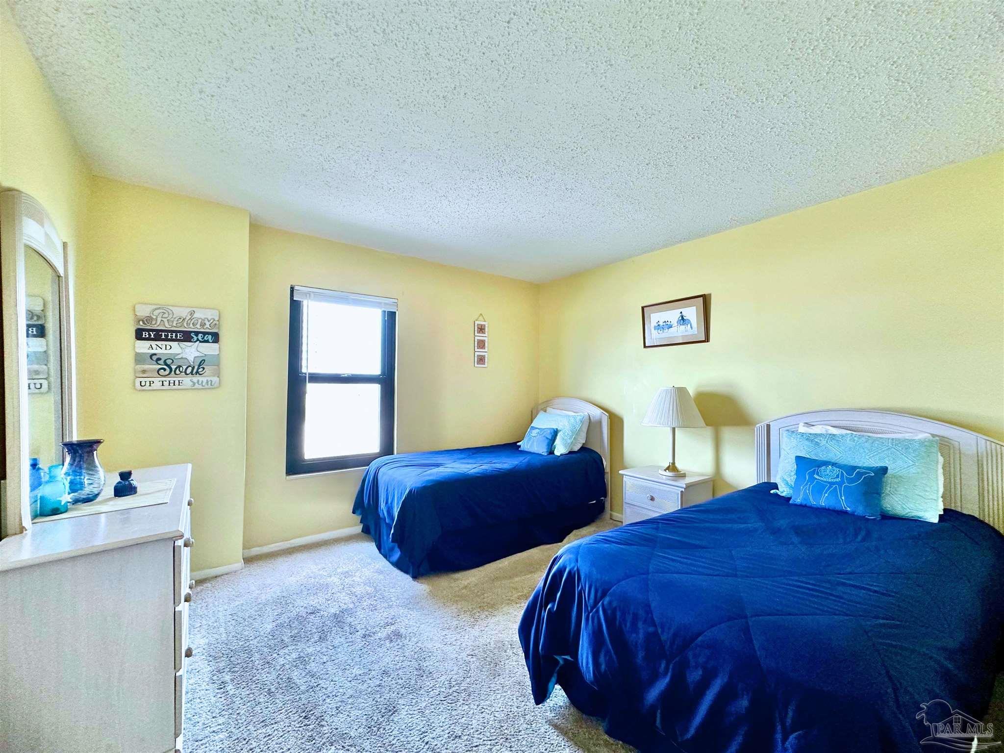 13817 Perdido Key Drive, Unit 204 Pensacola, FL 32507 - Photo 21 of 27 a bedroom with two beds and a dresser