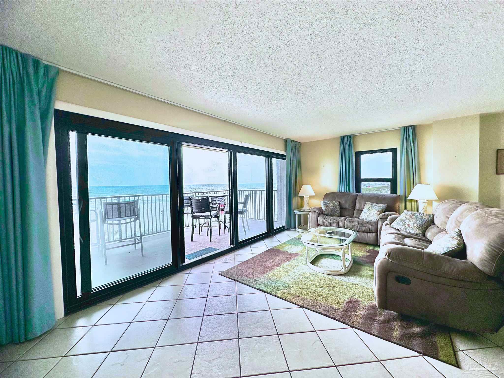 13817 Perdido Key Drive, Unit 204 Pensacola, FL 32507 - Photo 4 of 27 a living room with furniture and large windows