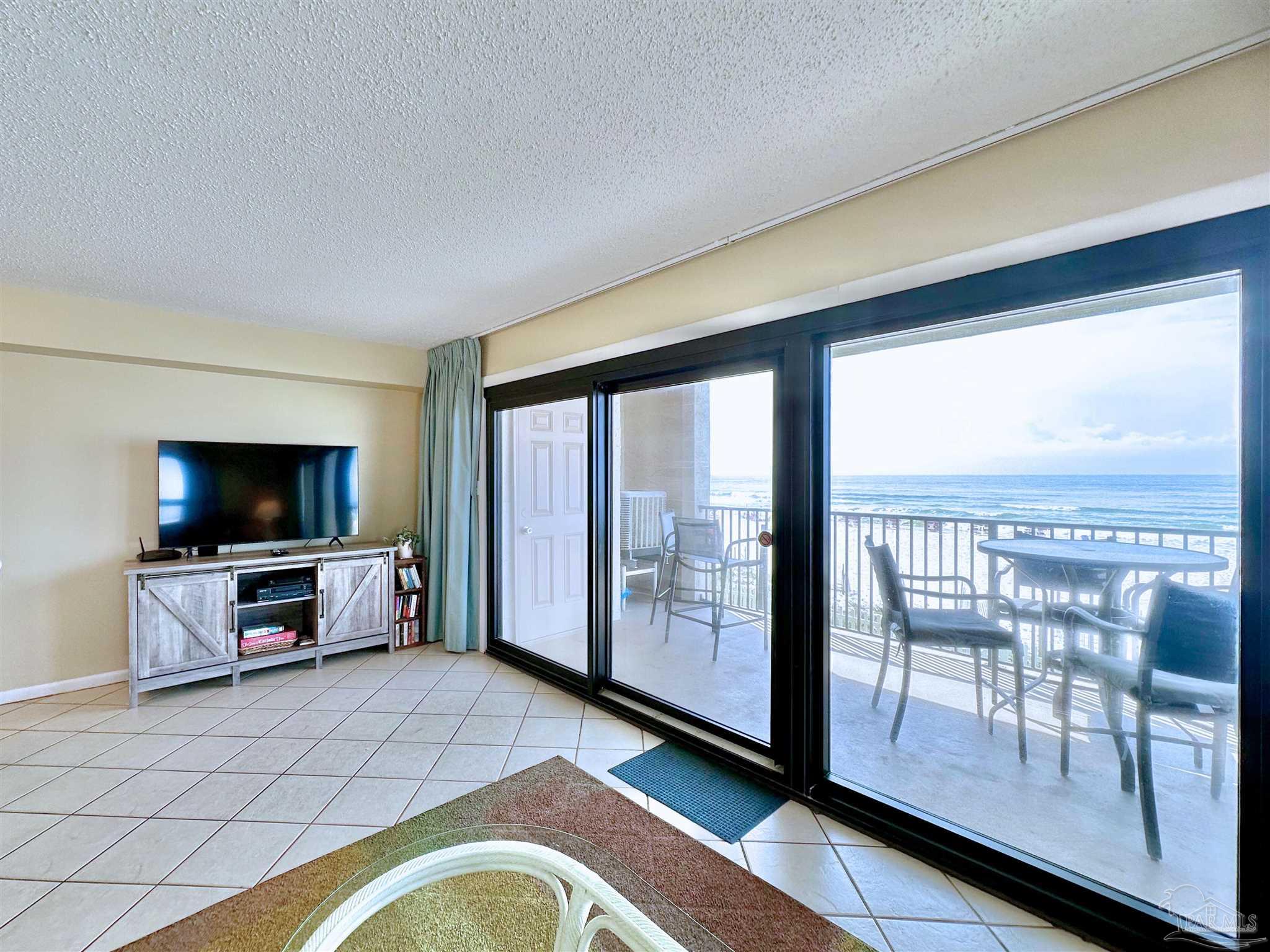 13817 Perdido Key Drive, Unit 204 Pensacola, FL 32507 - Photo 5 of 27 a living room with furniture and a flat screen tv