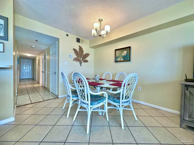 a dining room with furniture and chandelier