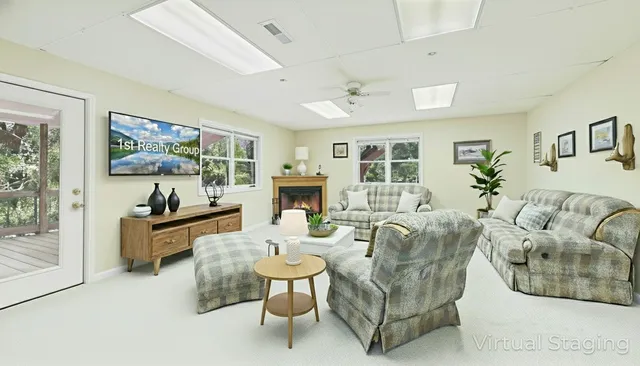 a living room with fireplace furniture and a flat screen tv