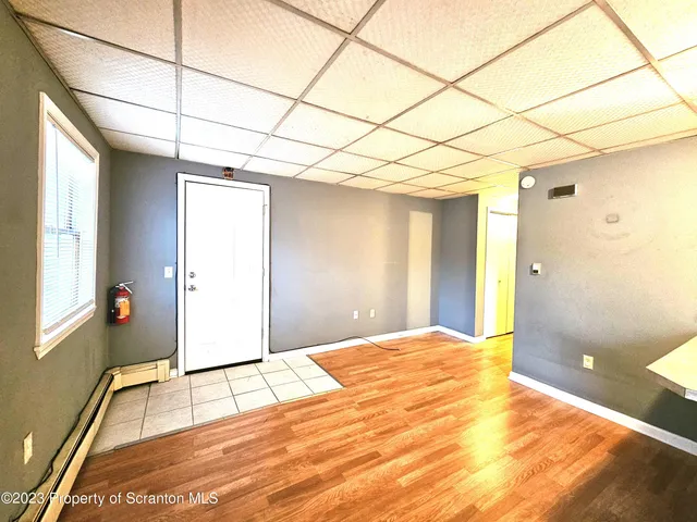 a view of a room with wooden floor and natural light