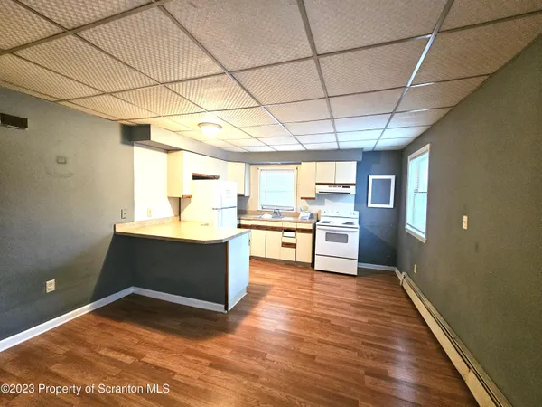 a view of kitchen with cabinets and wooden floor